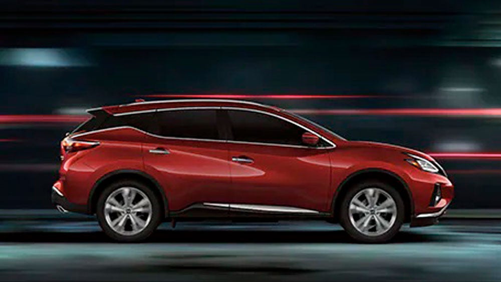 2023 Nissan Murano shown in profile driving down a street at night illustrating performance. | Moses Nissan of Huntington in Huntington WV